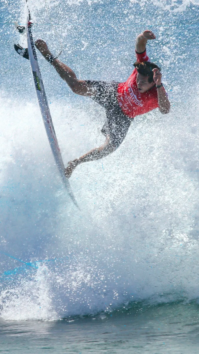 Surfer launching an air off a breaking wave at the Pacífico Surf Open Cerritos