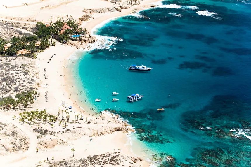 Chileno Beach from above, with clear turquoise water and boats close to shore