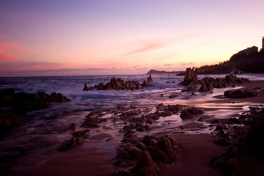 Rocks and tide pools at Las Viudas Beach at dusk, on the Los Cabos Tourist Corridor