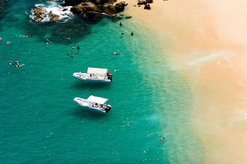 Turquoise water and boats off the shore of Lover's Beach, seen from above, Cabo San Lucas