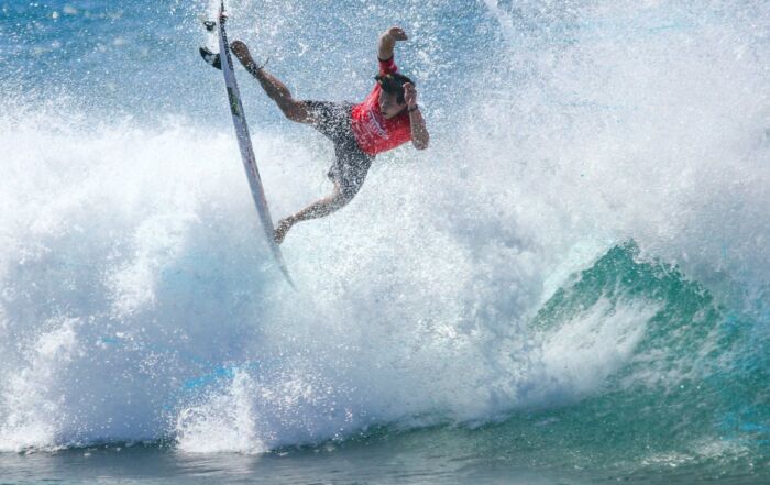 Surfer launching an air off a breaking wave at the Pacífico Surf Open Cerritos